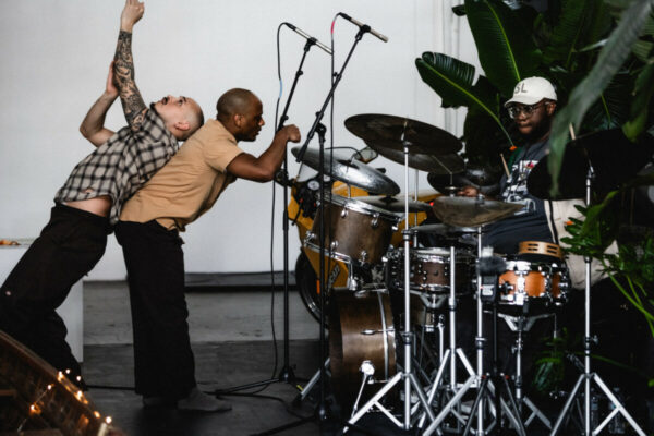 Heidi Duckler Dance NW 2026 Come As You Are Festival presented by Heidi Duckler Dance NW. Dancers Charles Roy and Daniel Girón with composer/percussionist Machado Mijiga, performing a prologue to a new site specific work inspired by John Steinbeck’s Grapes of Wrath. March 14, 2026. Photo by Jason Quigley.